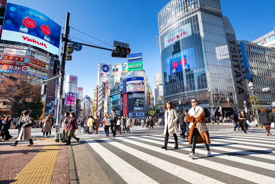 Locals walking across the famous Shibuya crossing in Tokyo, Japan