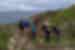 A group hiking and stopping for a photo in a beautiful scenery near Cornwall in the UK