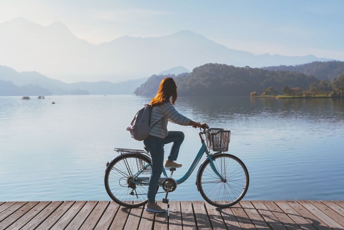 Traveller rides a bike along Sun Moon Lake in Taiwan