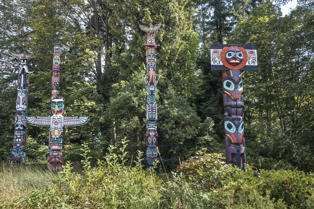 Totem poles amongst trees in British Columbia, Canada