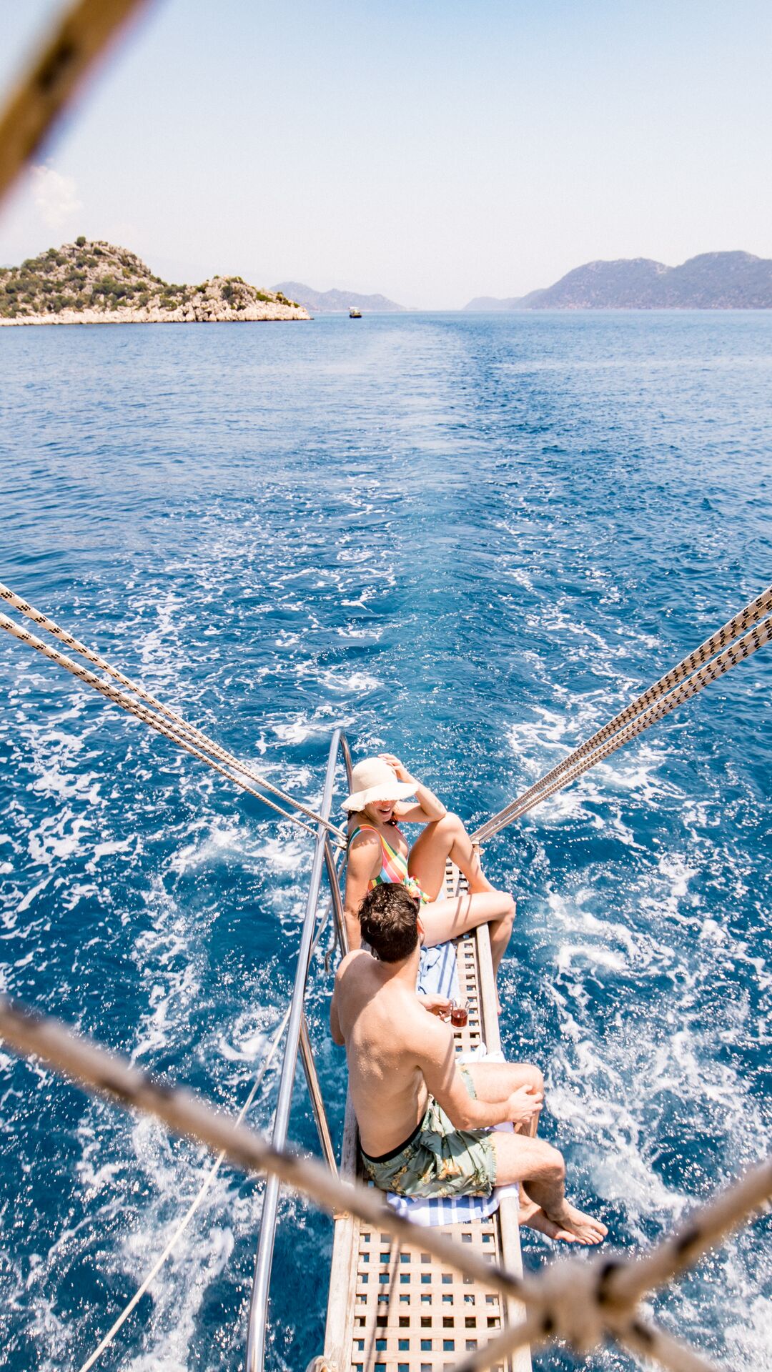 Two travellers sit on a gulet sailing in Turkey.