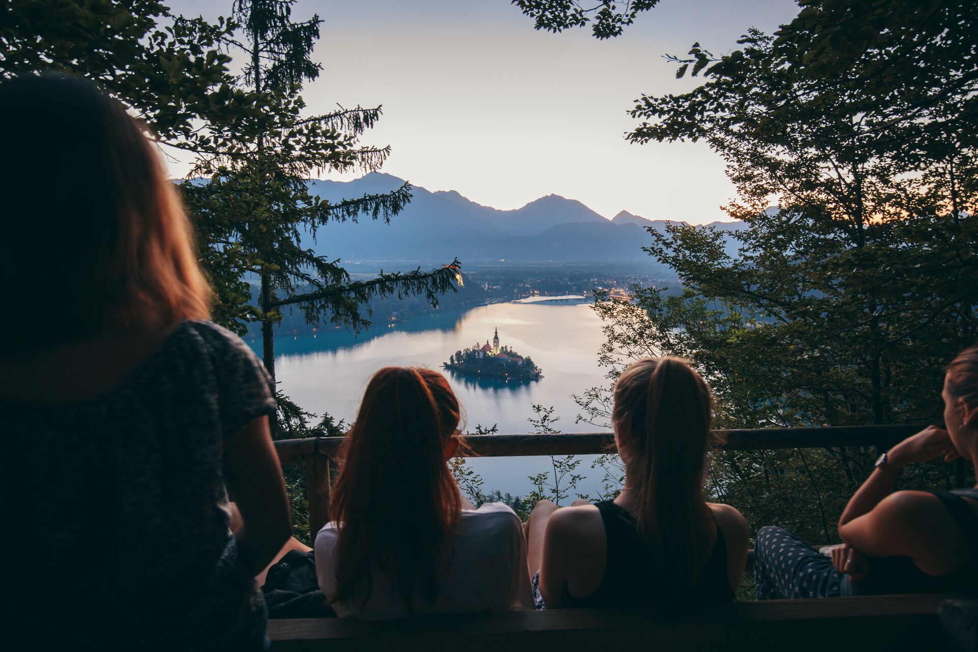 Watch the sun set on the mirror of Lake Bled in the mountains of Slovenia
