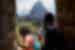 Intrepid travellers at Machu Picchu emerges from tunnel building looking at Huayna Picchu in Peru