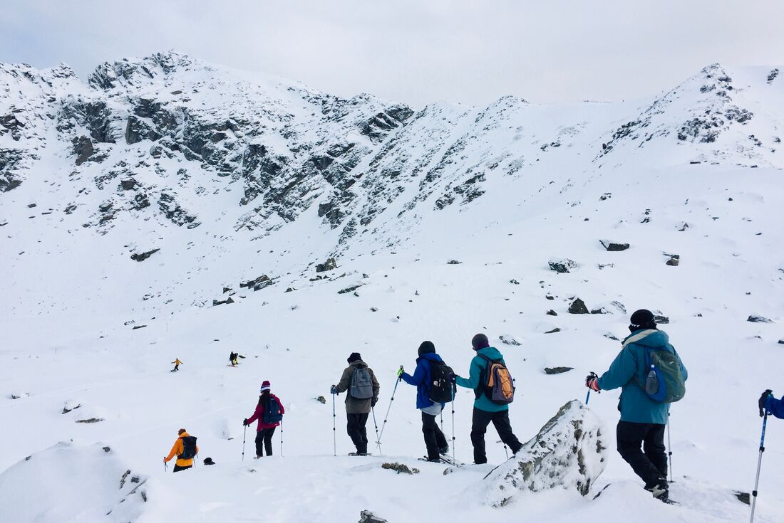 Travellers snowshoeing across the snow in New Zealand