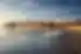 Santa Monica Pier at sunrise seen from LA Beach with Pacific Park behind in Los Angeles California USA