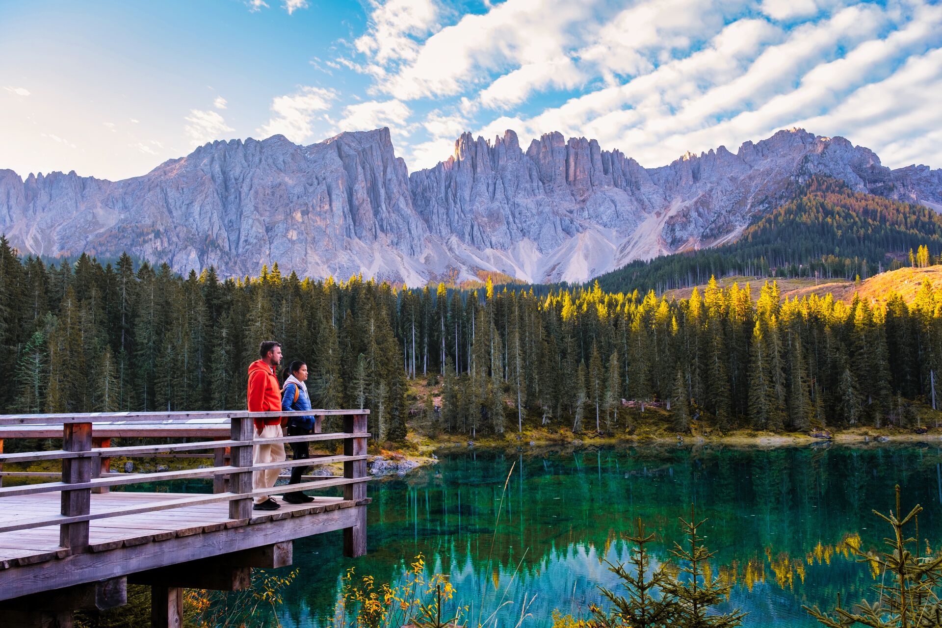 Taking in the crystal blue green waters of Carezza Lake between the Rosengarten and Latemar Massifs 