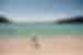 Traveller walking on the beach at Wineglass Bay in Tasmania, Australia