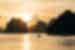 Halong Bay.at sunset with a fishing boat cutting across the water