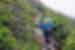 A hiker ascending a mountain path in Northern Vermont, USA