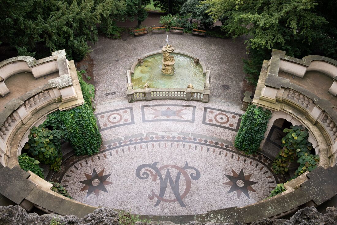 Fountain and sheltered mosaic grotto with marble columns in Grébovka Park in Prague
