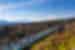 Wide view of travellers walking along Mishima Skywalk with Mt Fuji in background