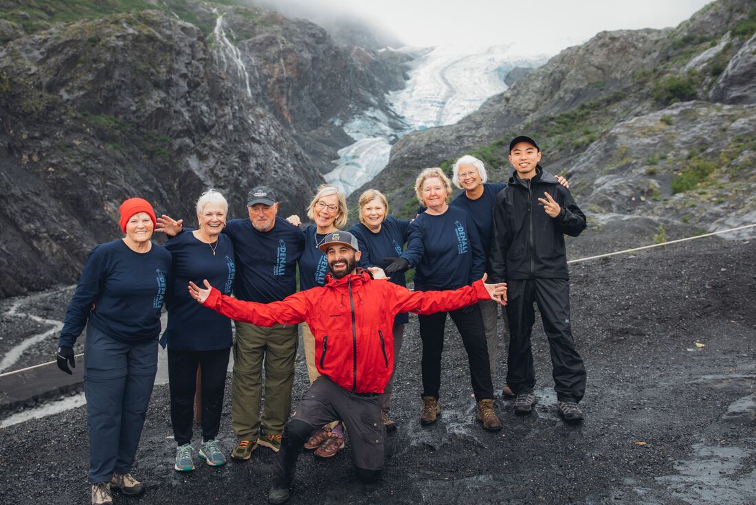 Group of Intrepid travellers hike up to a lookout over Exit Glacier near Seward Alaska