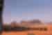 Square black tents with gold bands arrayed further from the camera in the desert of Wadi Rum in Jordan