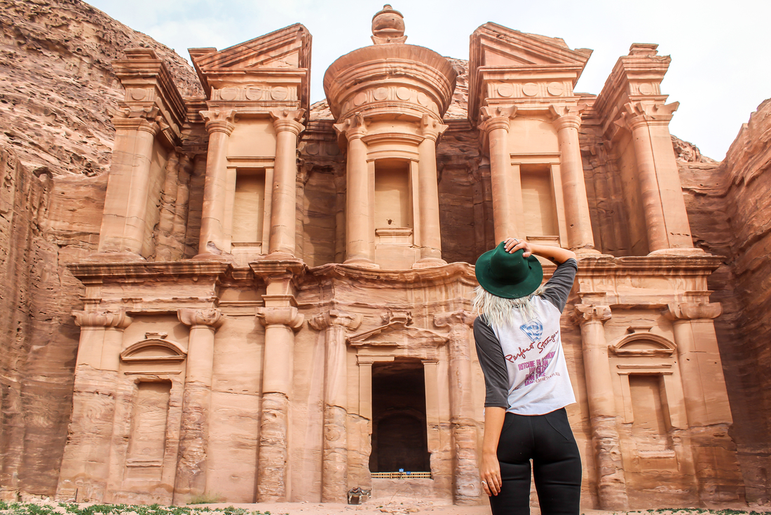 Traveller looking of at the ruins of Petra, Jordan