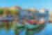 Moliceiro boats in the canals of Aveiro Portugal with the town square and classic Portuguese architecture beyond