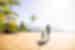 Mother and daughter run along the palm scattered Dominical Beach, Costa Rica