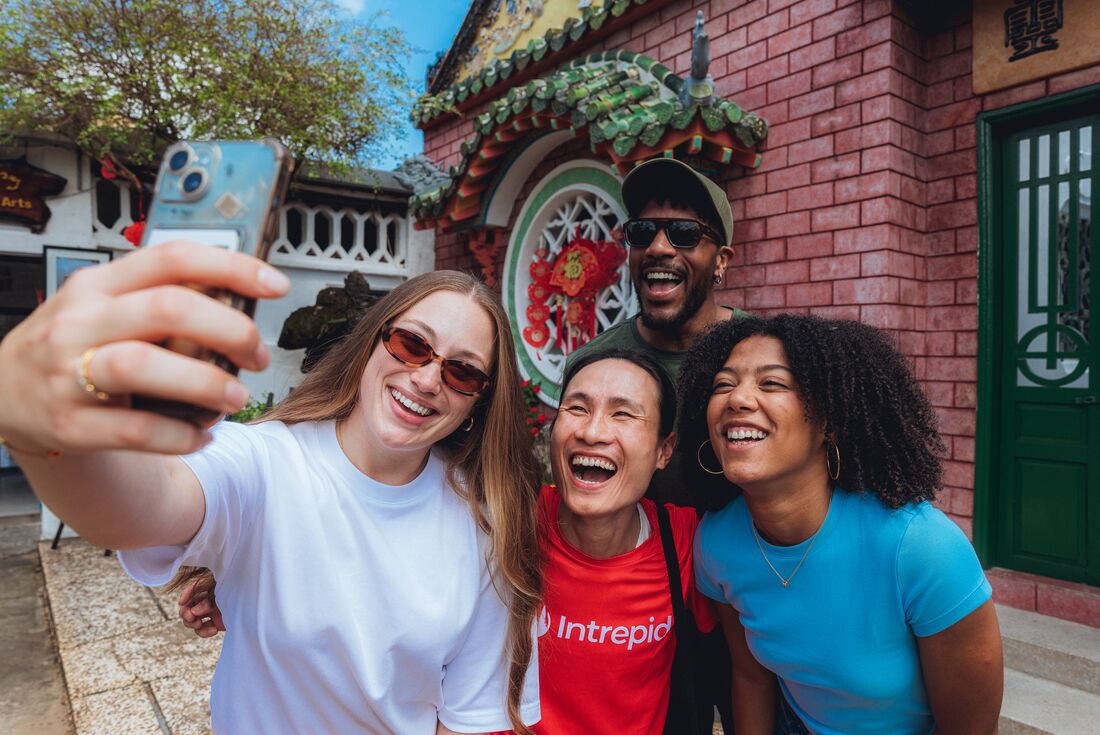 Travellers take a selfi with their Intrepid Leader at the Fujian Assembly Hall in Hoi An, Vietnam