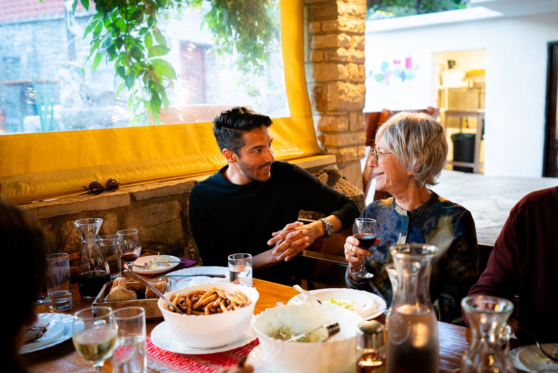 Travellers chat over a meal at Zrnovo's family owned restaurant in Korcula, Croatia