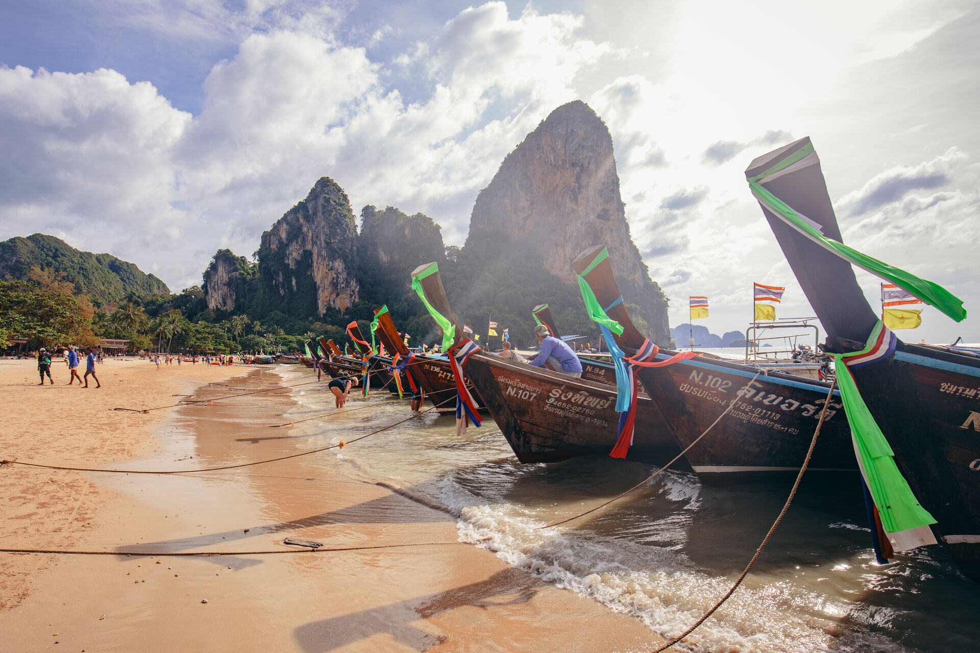 Longtail boats with bright colours anchored on the beaches of Krabi Islands