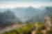 Two travellers come up the mountainside, hiking to Pico do Ruivo on Madeira island in Portugal