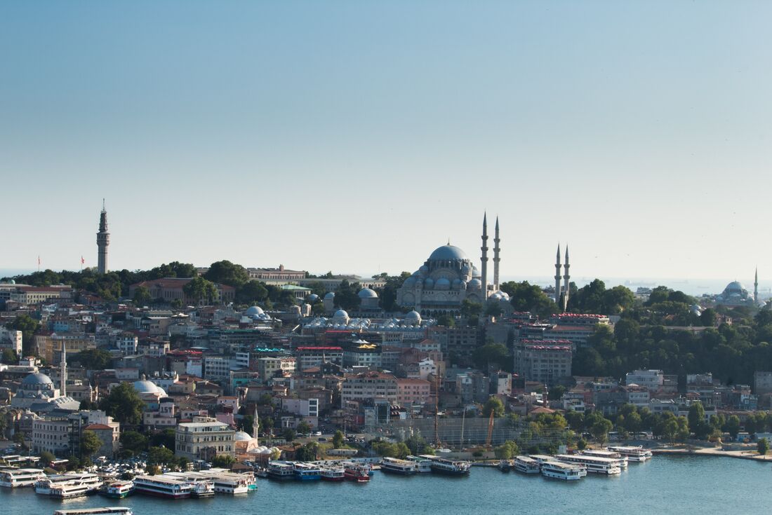 a wide view of the city scape with the Bosphorus in the foreground and Blue Mosque in the city line, Istanbul, Turkey