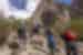 Travellers hiking from Kanday to Mingulo Broq up a sharp incline of rock in Karakoram Mountains