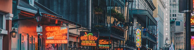Signage and french housing on Bourbon Street in New Orleans