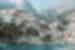 View of buildings of Minori town stacking up the hill-topped cliffs of Minori town on the Amalfi Coast, from the water