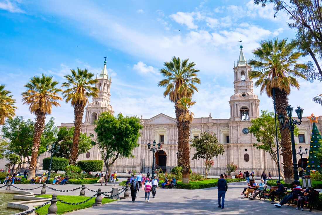 Plaza de Armas in Arequipa with palm trees and Cathedral of Arequipa