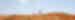 Two people walk along the red sandy path of a ridge in the Kimberleys