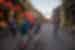 Travellers walking down a twilit street with red lanterns adorning building down the street in Hoi An, Vietnam on an Intrepid Travel tour.