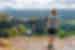 Intrepid traveller stands high taking in Presbischtor Gate in Czechia's mountains