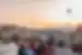 Travellers enjoying the view of hot air balloons at sunset while drinking tea, Cappadocia, Turkey