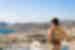 Traveller enjoying the view over the town and mountainous landscapes in Syros, Greece