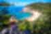 Traveller in sun hat looks out at Magnetic Island Beach