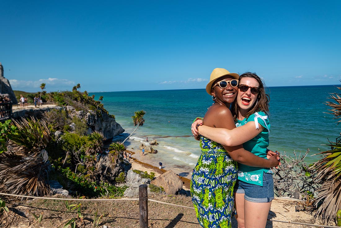 QBPN - Friends posing in front of beach in Tulum, Mexico