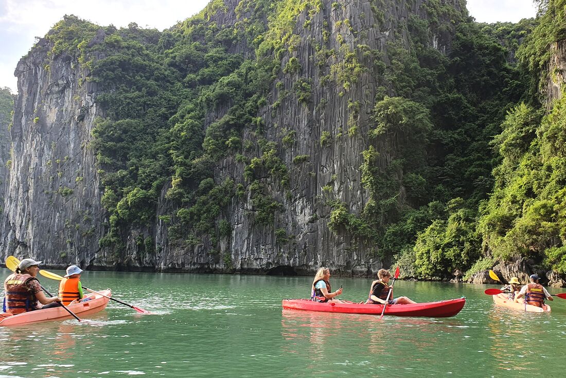 Group of family travellers kayaking in Halong Bay, Vietnam
