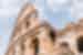 Looking up at the architecture of the Colosseum in Rome, the capital of Italy with a sky backdrop
