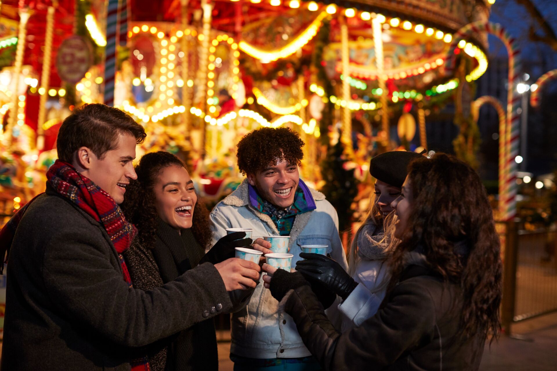 Sharing some mulled wine with other travellers in Riga's Christmas markets outside the carousel