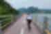 Traveller cycling on the 4 Rivers Bike Trail on a suspended bike path over the waters of the Han River in South Korea