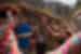 Young Intrepid traveller smiles while dancing with locals of the Huilloc community in the Sacred Valley