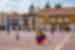Brightly coloured dressed Palenquera selling fruit in Cartagena town square in Colombia