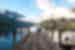 Travellers sit at the end of a pier on Lake Rotoiti in Nelson Lakes National Park in New Zealand