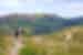 Group hiking up hills on Scottish landscape