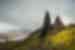 Travellers look up at the towering Old Man of Storr on the Isle of Skye in Scotland