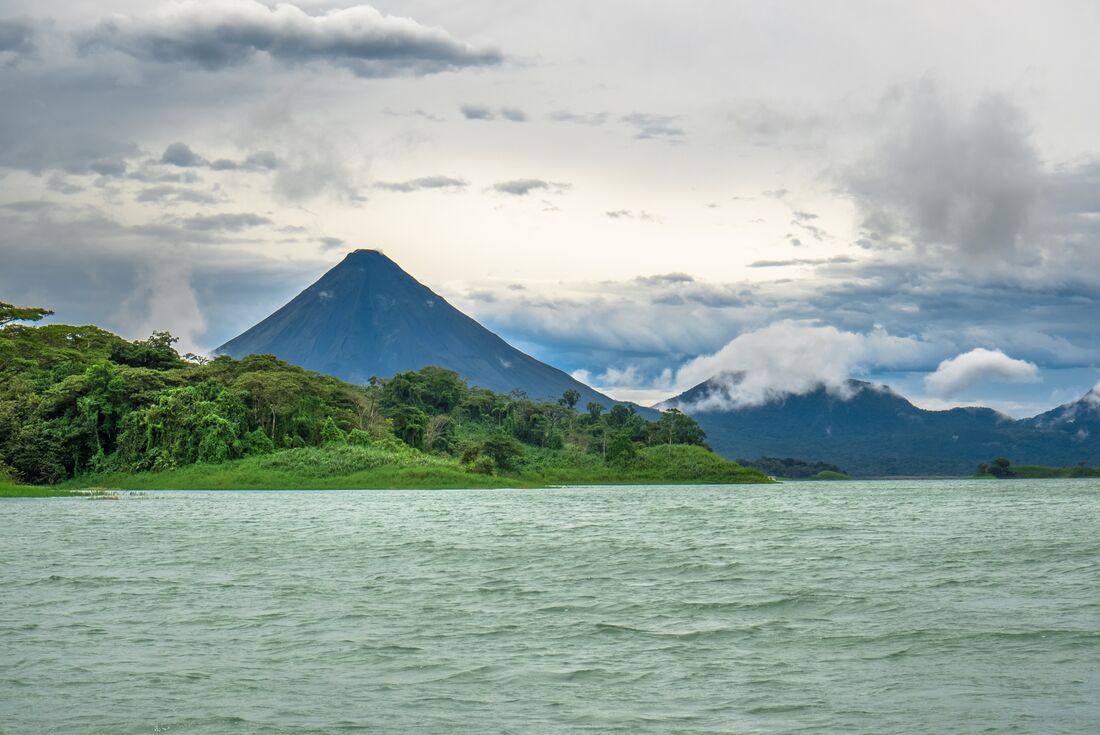 Arenal Volcano looms over the rainforests and waters of Costa Rica