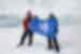 Travellers posing with Intrepid flag in Antarctica