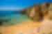 View of travellers gathered on Lagos Beach by thge cliff side, Portugal