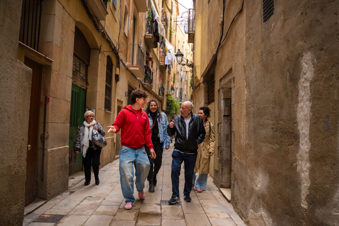 A tour leader shows travellers the streets of Barcelona, Spain.
