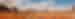 A landscape panorama of Monument Valley in Arizona with tall sandstone buttes